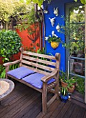 KARLA NEWELL GARDEN  BRIGHTON: SMALL TOWN GARDEN WITH BLUE WALL  WOODEN BENCH AND DECKING