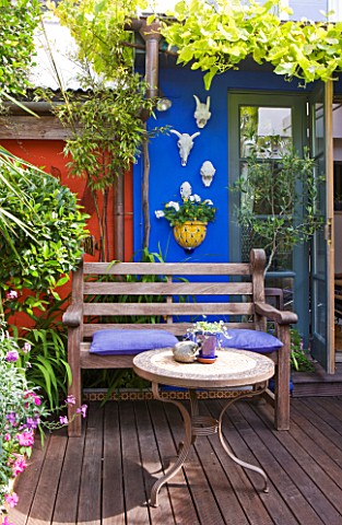 KARLA_NEWELL_GARDEN__BRIGHTON_SMALL_TOWN_GARDEN_WITH_BLUE_WALL__WOODEN_BENCH__TABLE_AND_DECKING