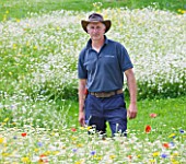 WHATLEY MANOR  WILTSHIRE: HEAD GARDENER BARRY HOLMAN IN THE SPA GARDEN WITH  ANNUAL WILDFLOWER MEADOW