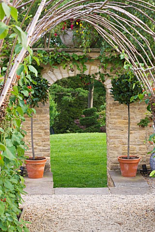 WHATLEY_MANOR__WILTSHIRE_THE_KITCHEN_GARDEN_VEGETABLE_GARDEN_POTAGER___IN_SUMMER__VIEW_OUT_OF_KITCHE