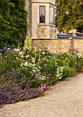 WHATLEY MANOR  WILTSHIRE: HERBACEOUS BORDER BESIDE THE HOTEL - LATE SUMMER  SUNSET
