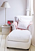 AMANDA KNOX HOUSE  GRANTHAM: THE WHITE LIVING ROOM - CHAIR AND FOOTSTOOL WITH WOODEN LAMP