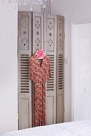 AMANDA_KNOX_HOUSE__GRANTHAM_BEDROOM_WITH_FRENCH_FOLDING_SHUTTERS_WITH_VINTAGE_DRESS_HANGING_OFF