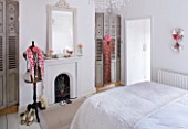 AMANDA KNOX HOUSE  GRANTHAM: BEDROOM WITH FRENCH FOLDING SHUTTERS  FIREPLACE WITH FRENCH MIRROR  OLD MANNEQUIN AND VINTAGE DRESS