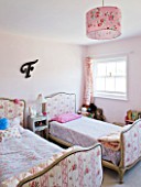 AMANDA KNOX HOUSE  GRANTHAM: CHILDRENS BEDROOM IN PALE PINK WITH VINTAGE BEDS  F FOR FLORA  SINGLE VINTAGE CURTAIN  LAMPSHADE FROM TK MAX