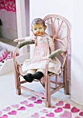 AMANDA KNOX HOUSE  GRANTHAM: CHILDRENS BEDROOM IN PALE PINK WITH VINTAGE DOLL IN PAINTED CHAIR  BOTH JUNK SHOP FINDS