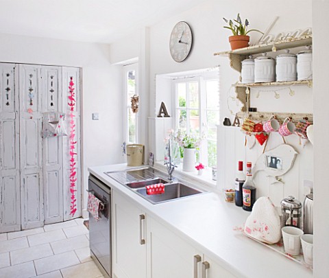 AMANDA_KNOX_HOUSE__GRANTHAM_WHITE_KITCHEN__GALLEY_KITCHEN_WITH_UTILITY_ROOM_SCREENED_BY_FOLDING_FREN