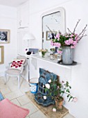 AMANDA KNOX HOUSE  GRANTHAM: WHITE DINING ROOM - WEATHERED TIN CONTAINER ON MANTELPIECE WITH HYDRANGEAS  BLUE FRENCH BENCH AND BLUE STOVE