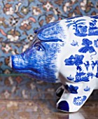 CHANTAL COADY HOUSE  LONDON: A BLUE AND WHITE PAINTED PIGGY BANK ON AN ANTIQUE CHEST OF DRAWERS IN THE MAIN BEDROOM