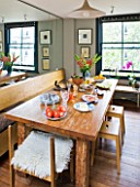 CHANTAL COADY HOUSE  LONDON: THE DINING ROOM WITH MIRRORED CUPBOARDS BEHIND. BALINESE TABLE