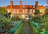 SALING HALL  ESSEX:  BRICK PATH LEADING TO HOUSE AND CONSERVATORY - EVENING LIGHT