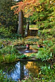 SALING HALL  ESSEX: THE WATER GARDEN IN AUTUMN WITH STONE STEPS AND TWO SHALLOW PONDS WITH A SINGLE WATER JET