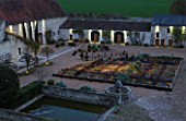 CHATEAU DU RIVAU  LOIRE VALLEY  FRANCE: VIEW OFTHE POTAGER AND THE GOLDEN FLEET BARN FROM THE CHATEAU AT NIGHT WITH LIGHTING