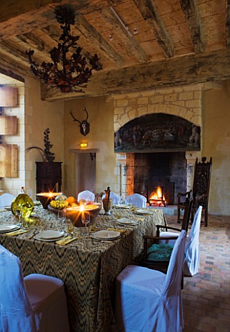 CHATEAU_DU_RIVAU__LOIRE_VALLEY__FRANCE_DINING_ROOM_IN_THE_CHATEAU_WITH_TABLE_LAID_AND_FIREPLACE