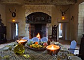 CHATEAU DU RIVAU  LOIRE VALLEY  FRANCE: DINING ROOM IN THE CHATEAU WITH TABLE LAID AND FIREPLACE