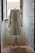 CHATEAU DU RIVAU  LOIRE VALLEY  FRANCE: WINDOW WITH WHITE DRESS ON STAND