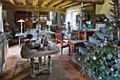 ROQUELIN  LOIRE VALLEY  FRANCE: SITTING ROOM WITH CHRISTMAS TREE   DISPLAY TABLE AND THE DINING AREA. WOODEN BEAMED CEILING