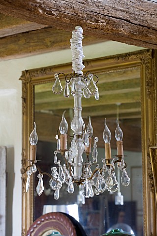 ROQUELIN__LOIRE_VALLEY__FRANCE_DINING_ROOM_DECORATIVE_GLASS_CHANDELIER_IN_FRONT_OF_VINTAGE_GILT_GLAS
