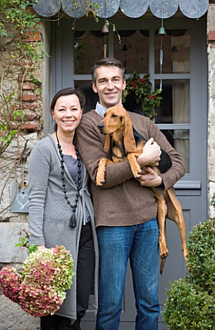 ROQUELIN__LOIRE_VALLEY__FRANCE_OWNERS_ALINE_AND_STEPHANE_CHASSINE_OUTSIDE_THEIR_RENOVATED_FARMHOUSE_