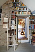 ROQUELIN  LOIRE VALLEY  FRANCE: UPPER HALL; BOOK SHELVES BUILT INTO THE EAVES OF THE UPPER HALL WITH LONG WOODEN LADDER FOR ACCESS