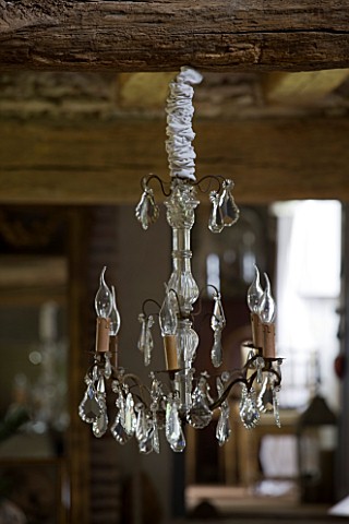 ROQUELIN__LOIRE_VALLEY__FRANCE_LIVING_ROOM_DECORATIVE_GLASS_CHANDELIER_HANGS_FROM_A__BEAM_IN_THE_LIV