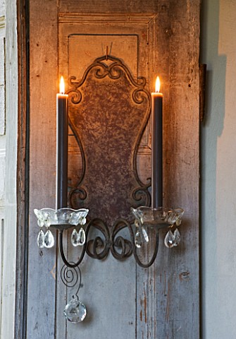 ROQUELIN__LOIRE_VALLEY__FRANCE_LIVING_ROOM_DECORATIVE_CANDLE_SCONCES_ON_A_WINDOW_SHUTTER_PROVIDE_EXT