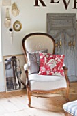ROQUELIN  LOIRE VALLEY  FRANCE: MASTER BEDROOM; REUPHOLSTERED VINTAGE CHAIR WITH VINTAGE FABRIC PATTERNED CUSHIONS