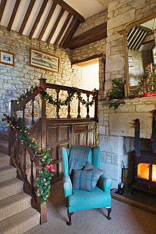 FULBROOK_HOUSE_GALLERIED_MAIN_HALL_WITH_COTSWOLD_STONE_FIREPLACE__LOG_BURNING_STOVE_AND_LEATHER_AND_