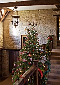 FULBROOK HOUSE: GALLERIED MAIN HALL WITH CHRISTMAS TREE AND STAIRCASE