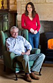 FULBROOK HOUSE: OWNER SIMON GILL AND PARTNER JACKY HOBBS IN THE HALLWAY BESIDE THE FIREPLACE