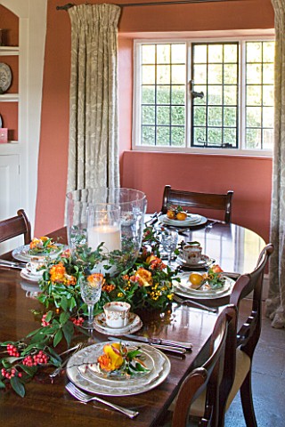 FULBROOK_HOUSE_DINING_ROOM_TERRACOTTA_PAINTED_WALLS_WITH_COTSWOLD_STONE_FLOOR__POLISHED_WOOD_TABLE_S