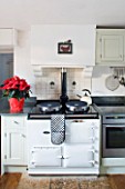 FULBROOK HOUSE: KITCHEN; BEAMED CEILING  NATURAL WOOD FLOORS  AGA AND SEASONAL RED POINSETTIA