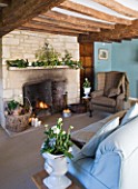 FULBROOK HOUSE: SITTING ROOM WITH BEAMED CEILING  COTSWOLD STONE FIREPLACE WITH FURNISHINGS IN AQUA AND PLAID WOOL.