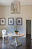 WHITE HOUSE: RECEPTION HALL: WHITE PAINTED WALLS WITH BLACK AND WHITE BALLET PICTURES  DARK POLISHED WOOD FLOOR WITH CENTRAL CIRCULAR TABLE AND UPHOLSTERED WHITE CHAIR