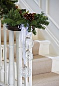 WHITE HOUSE: RECEPTION HALL: MAIN STAIRCASE  BANISTER DRESSED WITH CHRISTMAS PINE AND CONE GARLAND