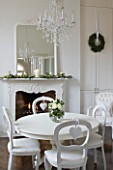 WHITE HOUSE: BREAKFAST ROOM: WHITE PAINTED TABLE AND CHAIRS  GLASS CHANDELIER AND WHITE FRAMED MANTLE MIRROR