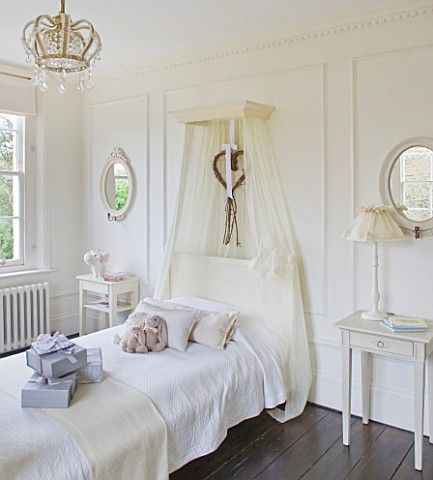 WHITE_HOUSE_GIRLS_BEDROOM_WITH_WHITE_WALL_PANELLING__OVAL_WALL_MIRRORS__CROWN_STYLE_LIGHT__SWEDISH_S