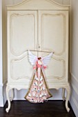 WHITE HOUSE: GIRLS BEDROOM - DARK WOODEN FLOORS  VICTORIAN FIREPLACE AND CREAM PAINTED ARMOIRE WITH CHRISTMAS ADVENT ANGEL.