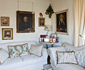 SARAH BAKERS HOUSE  THE OLD VICARAGE  SOMERSET: SITTING ROOM; CREAM DECORATION AND FURNISHINGS ACCESSORISED WITH BAKER AND GRAY CUSHIONS AND VINTAGE PAINTINGS.