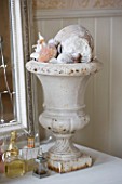 SARAH BAKERS HOUSE  THE OLD VICARAGE: BATHROOM : VINTAGE GARDEN URN SPILLING WITH SHELLS AND CORAL.
