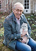 DR RONALD MACKENZIE  OXFORDSHIRE: DR RONALD MACKENZIE IN HIS GARDEN IN JANUARY WITH HIS CAT HARRIS