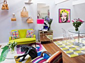 TARA NASH-KING HOUSE  LONDON: LIVING ROOM WITH DESIGNERS GUILD LINEN SOFA WITH GRAHAM & GREEN EMBROIDERED CUSHIONS  HANDBAGS ON WALL  MARILYN MONROE PRINT AND TABLE AND CHAIRS