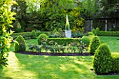 GRANGE COURT  GUERNSEY: THE FORMAL ROSE GARDEN WITH CLIPPED BOX AND MIRRORED OBELISK AT CENTRE
