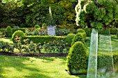 GRANGE COURT  GUERNSEY: THE FORMAL ROSE GARDEN WITH CLIPPED BOX AND MIRRORED OBELISK AT CENTRE