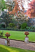 GRANGE COURT  GUERNSEY: THE MAIN LAWN WITH GRAVEL PATH AND STONE URNS/ CONTAINERS
