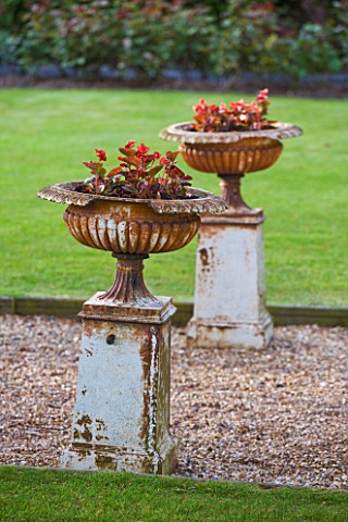 GRANGE_COURT__GUERNSEY_STONE_URNS_ON_PLINTHS_BY_GRAVEL_PATH_NEXT_TO_LAWN