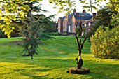 DUDMASTON ESTATE  SHROPSHIRE. THE NATIONAL TRUST. MAY 2012 -  METAL SCULPTURE AT SUNSET WITH HOUSE BEHIND