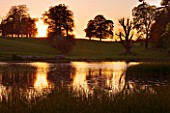 DUDMASTON ESTATE  SHROPSHIRE. NATIONAL TRUST. MAY 2012 - VIEW ACROSS THE LAKE AT SUNSET WITH REFLECTIONS ON THE WATER