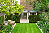 GARDEN DESIGNED BY  BUTTER WAKEFIELD  LONDON: SMALL CITY GARDEN WITH LAWN  YEW HEDGES AND GARDEN BUILDING BY TOWN & COUNTRY