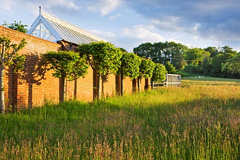 GIPSY_HOUSE__BUCKINGHAMSHIRE_THE_MEADOW_WITH_THE_WALLED_GARDEN_AND_GLASSHOUSE
